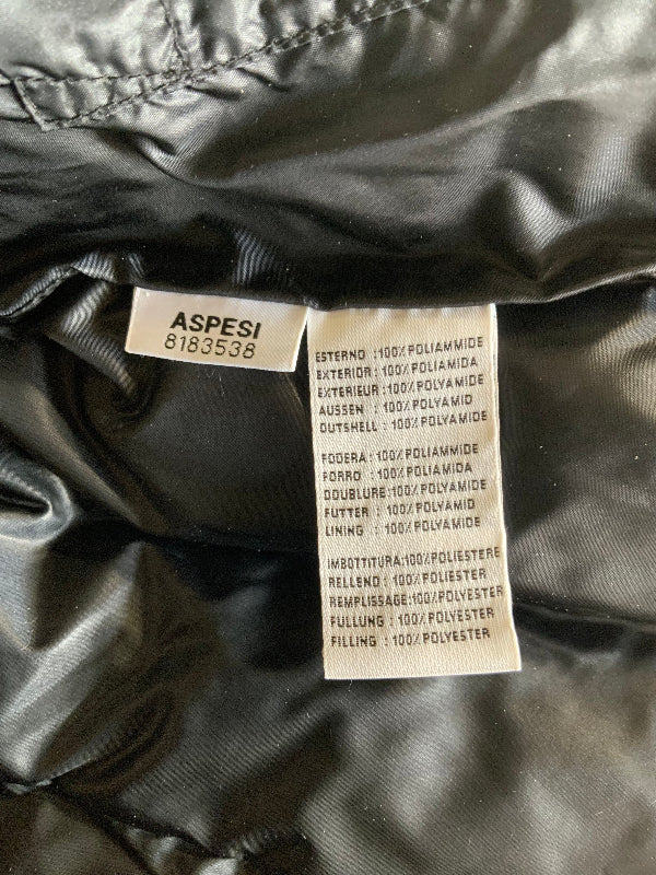 Close-up of the interior labels of a black puffer jacket, showing the brand name ASPESI and product details in French and English.