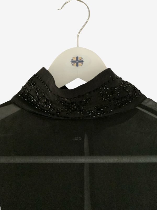 A black sheer mesh top with a high embroidered collar, hanging on a white hanger with a small Union Jack logo.