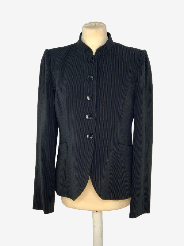 A black long-sleeve jacket with a mandarin collar and five front buttons, displayed on a beige mannequin torso against a plain white background.