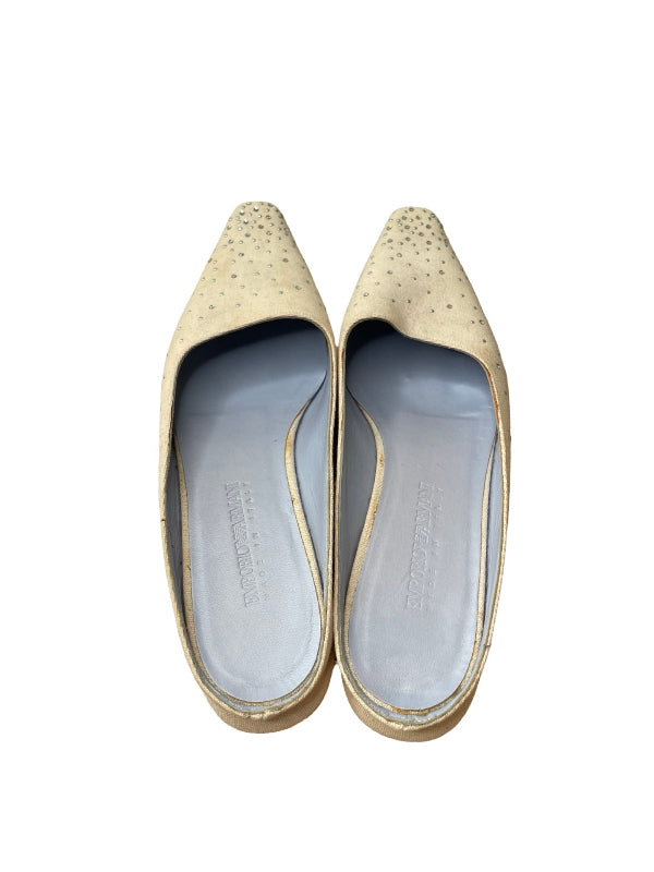 A pair of pointed-toe flats in a textured beige fabric with small metallic studs, shown from a top-down view on a white background.