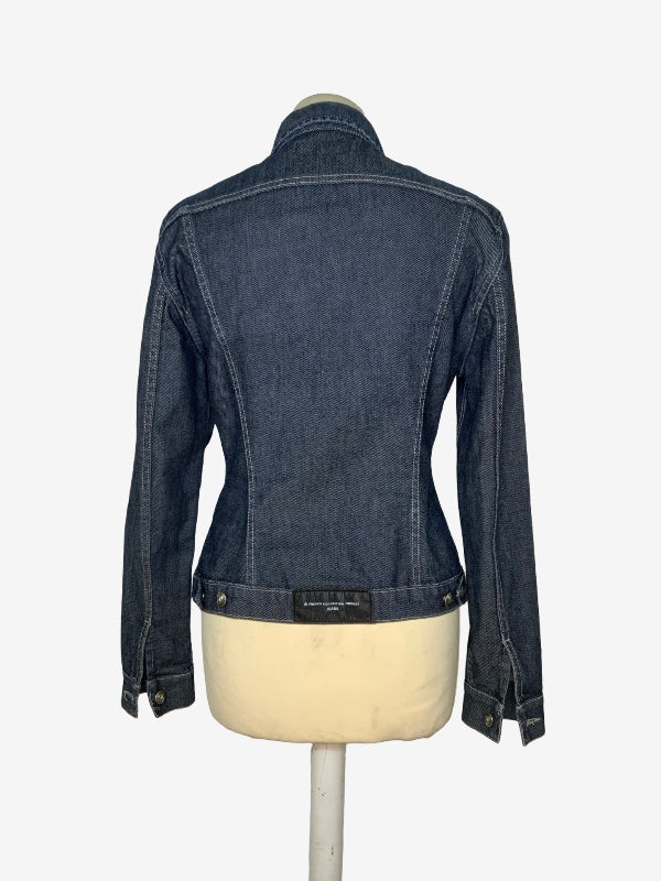 A dark blue denim jacket shown from the back on a cream-colored dress form mannequin, against a plain white background.