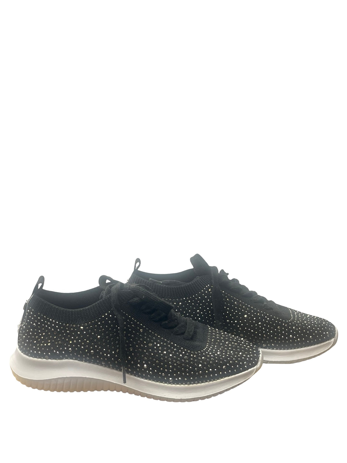 A pair of black knit low-top sneakers covered in silver rhinestones, featuring black laces and a white midsole with a gum outsole, shown against a plain white background.