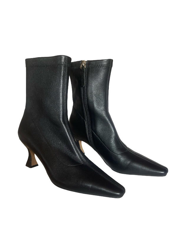 A pair of black leather ankle boots with pointed toes and mid-height kitten heels, shown against a plain white background.