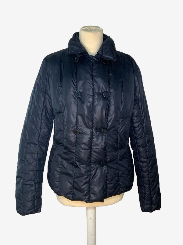 A black quilted puffer jacket with a double-breasted button closure and a high collar, displayed on a mannequin torso against a light gray background.