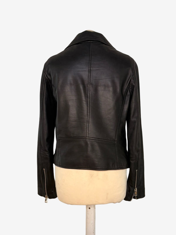 A black leather motorcycle jacket shown from the back, displayed on a cream-colored mannequin torso against a plain white background.