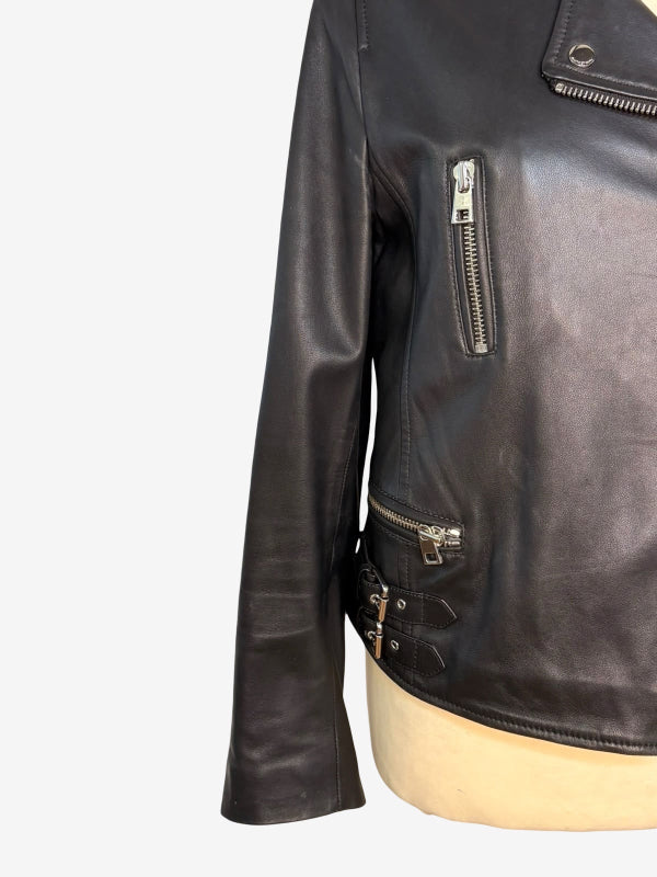 A close-up of a black leather motorcycle jacket displayed on a beige mannequin torso against a plain white background.
