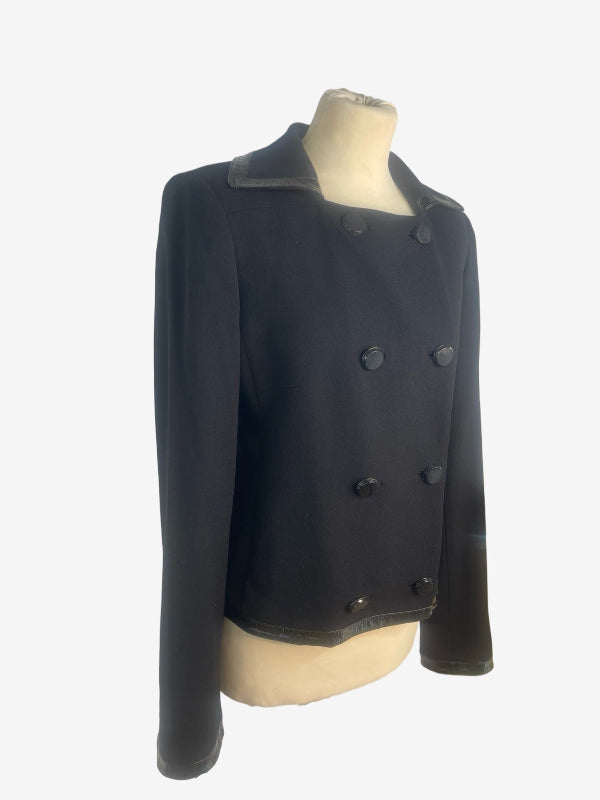 A black double-breasted cropped jacket with a notched lapel collar, displayed on a beige mannequin torso against a light gray background.