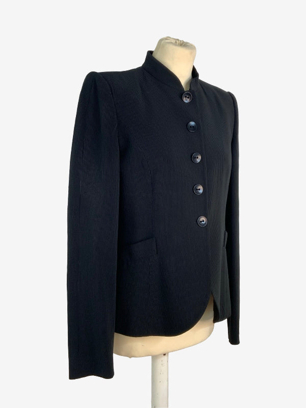 A black long-sleeve jacket with a mandarin collar and decorative dark buttons, displayed on a cream-colored mannequin torso against a plain white background.