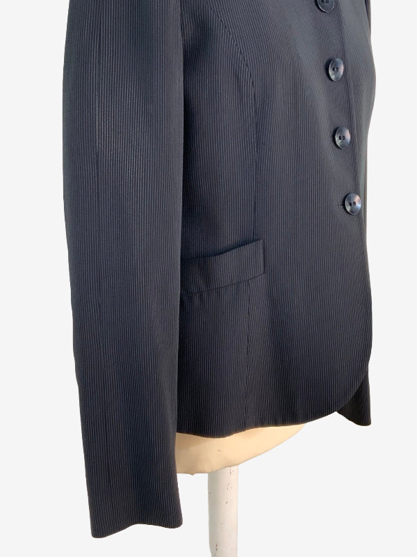 A close-up of a black pinstriped blazer jacket displayed on a mannequin torso against a plain white background.