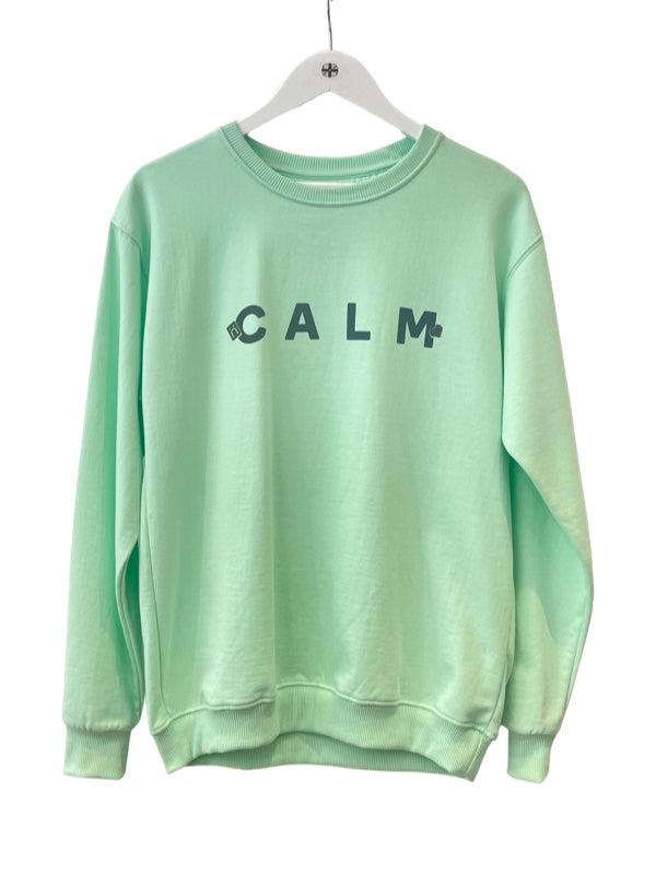 Pale green sweatshirt with Calm in dark blue black writing