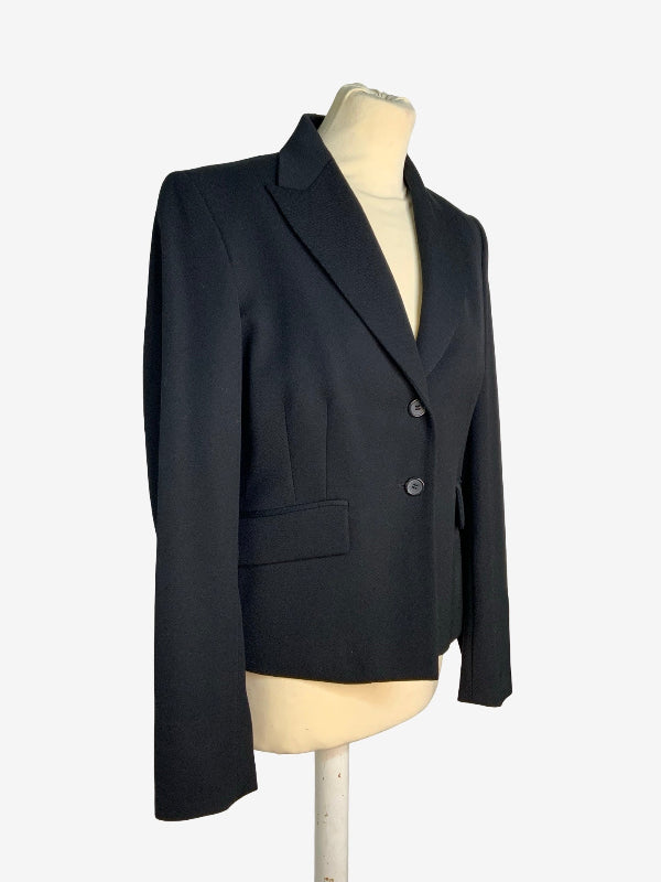 A black tailored blazer jacket displayed on a cream mannequin torso against a plain light background.