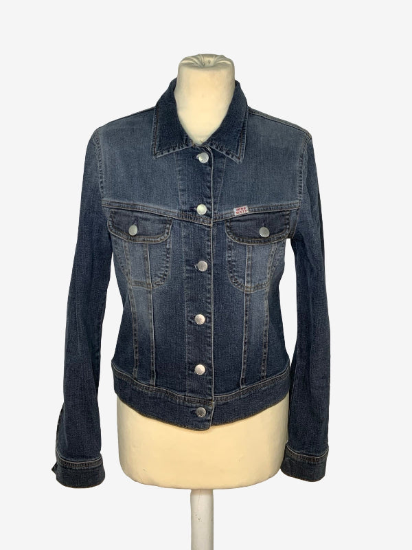 A dark wash blue denim jacket displayed on a cream-colored mannequin torso against a light gray background.