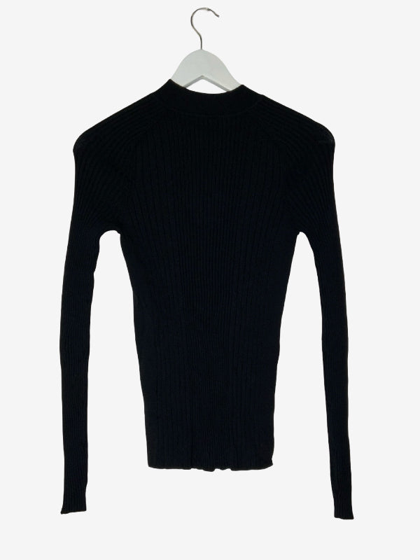 A black ribbed long-sleeve mock neck sweater hanging on a white hanger against a light gray background.