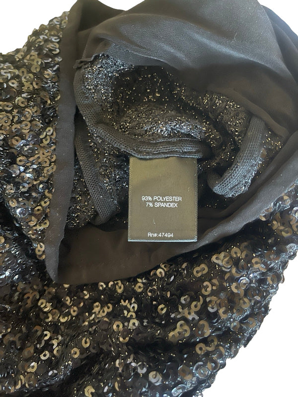 A close-up of a black sequined fabric garment or textile with a dark gray inner lining and a sewn-in size tag reading '60% POLYESTER 7% SPANDEX' and 'Rwr-47464'.