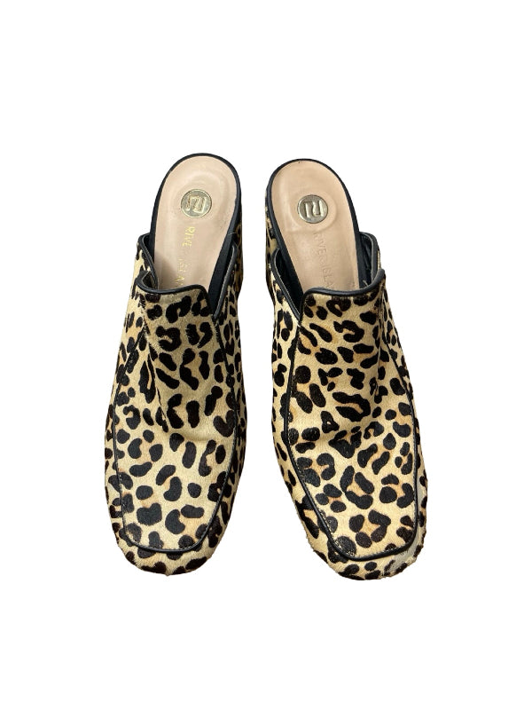 A pair of women's slip-on clogs with a beige and black leopard print pattern, shown from a top-down view on a white background.
