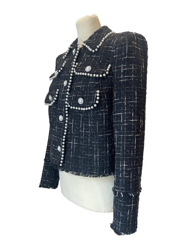 Side view of cropped tweed box jacket black and white with pearl buttons