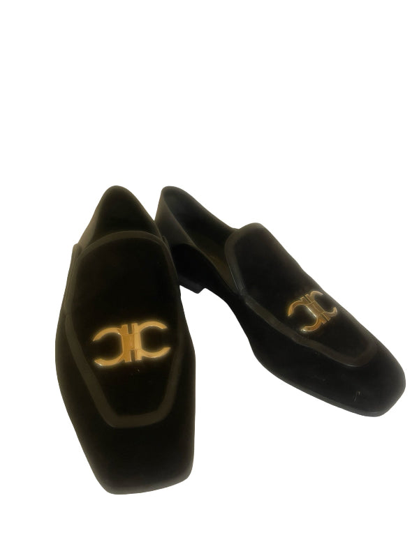 A pair of black velvet loafers with a silver-tone double-C logo on the vamp, displayed against a solid white background.