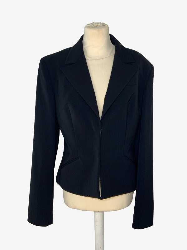 A black tailored blazer jacket displayed on a cream-colored mannequin torso against a light gray background.