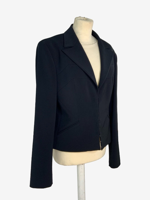 A black long-sleeve blazer jacket displayed on a cream-colored mannequin torso against a plain white background.