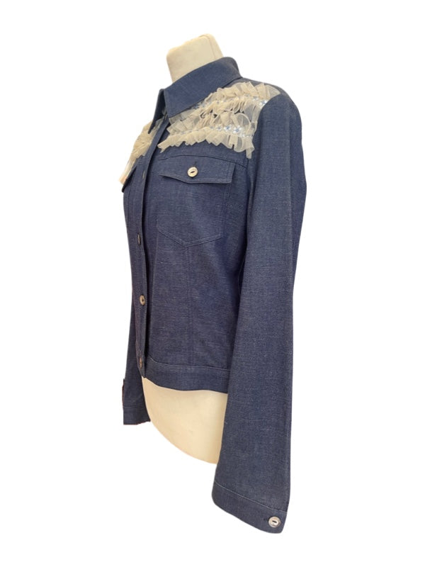 Denim jacket from the side with off white tulle detail at shoulder