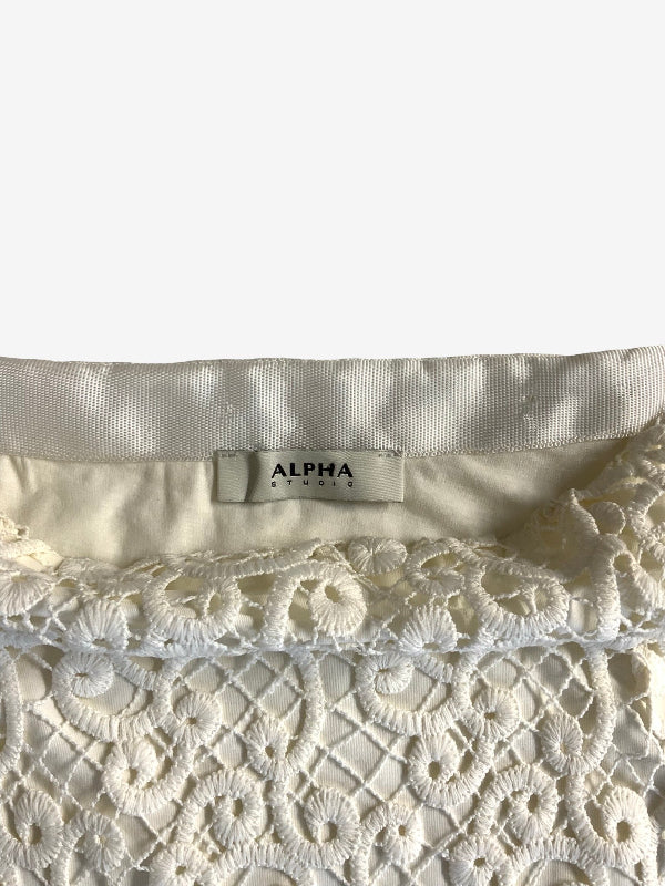 Close-up of a cream-colored lace skirt with a satin inner band and a visible neck label reading ALPHA Studio.