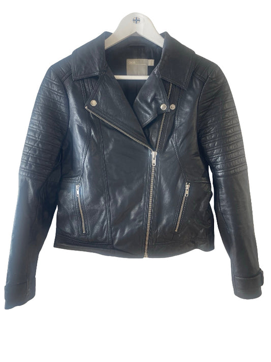 A black leather moto jacket with silver zippers and quilted sleeve panels, hanging on a white hanger against a white background.