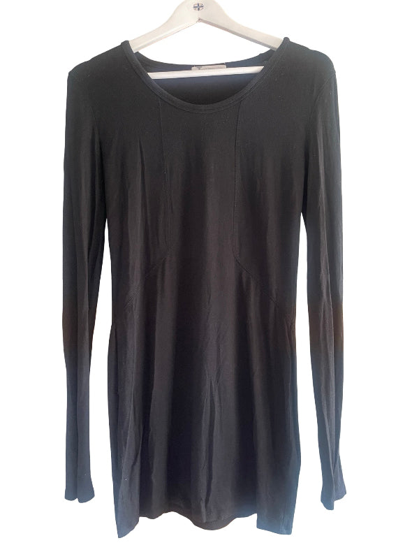 A black long-sleeve tunic top with a wide scoop neckline, hanging on a white wooden hanger against a plain white background.