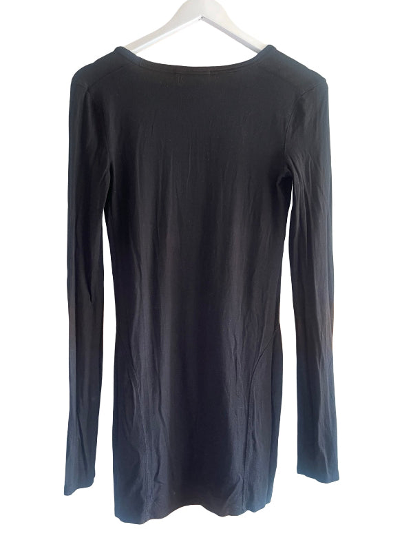 A black long-sleeve top hanging on a white hanger against a plain white background