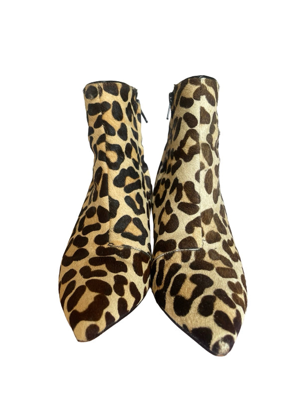 A pair of pointed-toe ankle boots with a leopard print pattern in beige, brown, and black, shown against a plain white background.