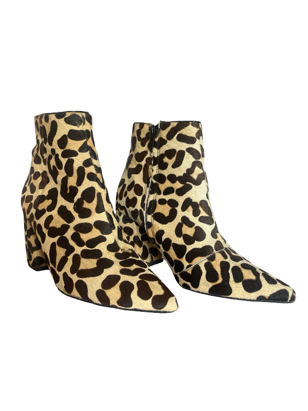 A pair of pointed-toe ankle boots with a leopard print pattern in beige, black, and brown, set against a plain white background.