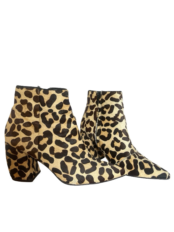 A pair of pointed-toe ankle boots with a leopard print pattern in beige, brown, and black, shown against a plain white background.