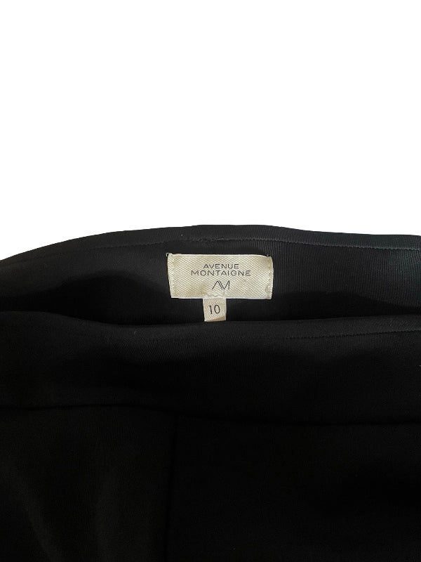 Close-up of the inner waistband of a black garment, showing a white size label that reads Avenue Montaigne and size M.