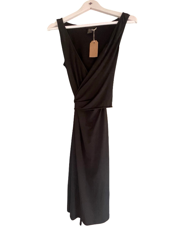 A black sleeveless wrap-style dress with a draped waist, hanging on a white wooden hanger against a plain white background.