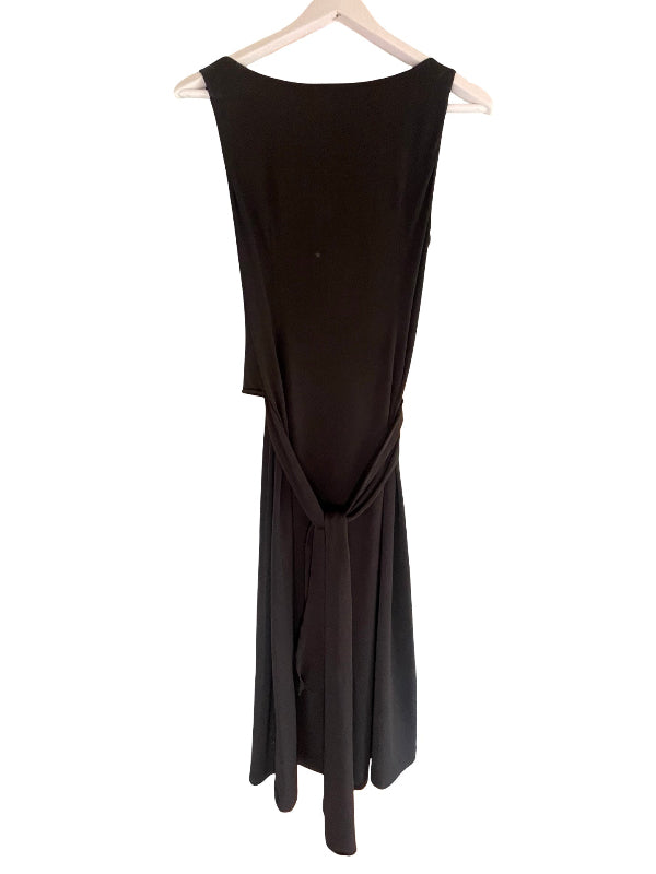 A sleeveless black dress with a draped, gathered waist and tie detail, hanging on a white wooden hanger against a plain white background.
