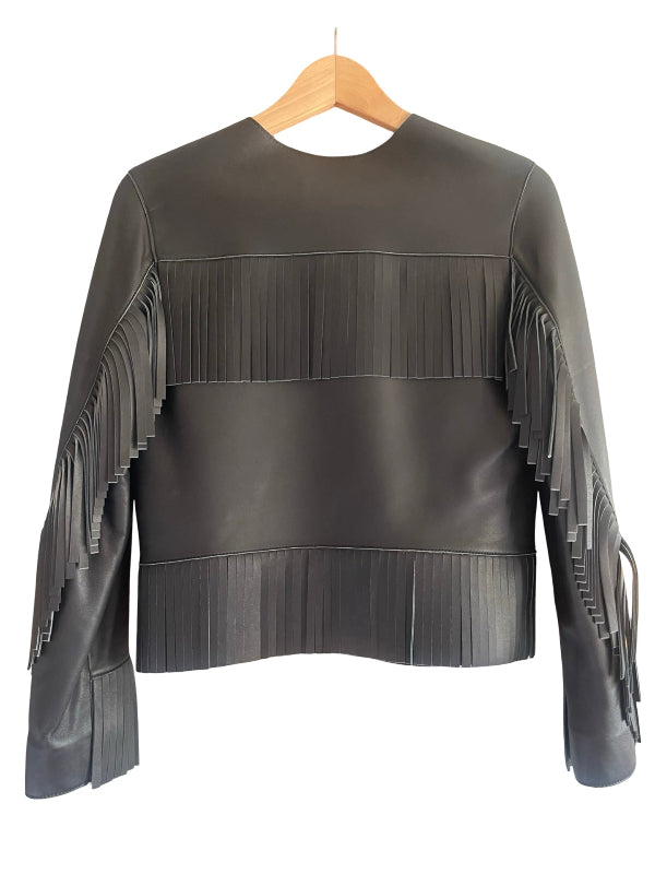A black leather fringe jacket with long sleeves, hanging on a wooden hanger against a white background