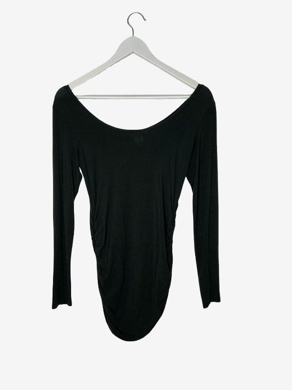A dark green  long-sleeve scoop-neck top hanging on a white hanger against a light gray background.