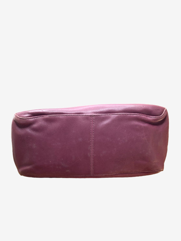 A dusty rose purple leather bottom of hand bag with a central vertical seam, shown against a plain light gray background.