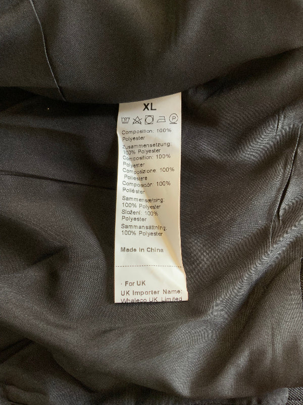 A close-up of a garment's interior showing a size XL care label sewn onto dark black fabric.
