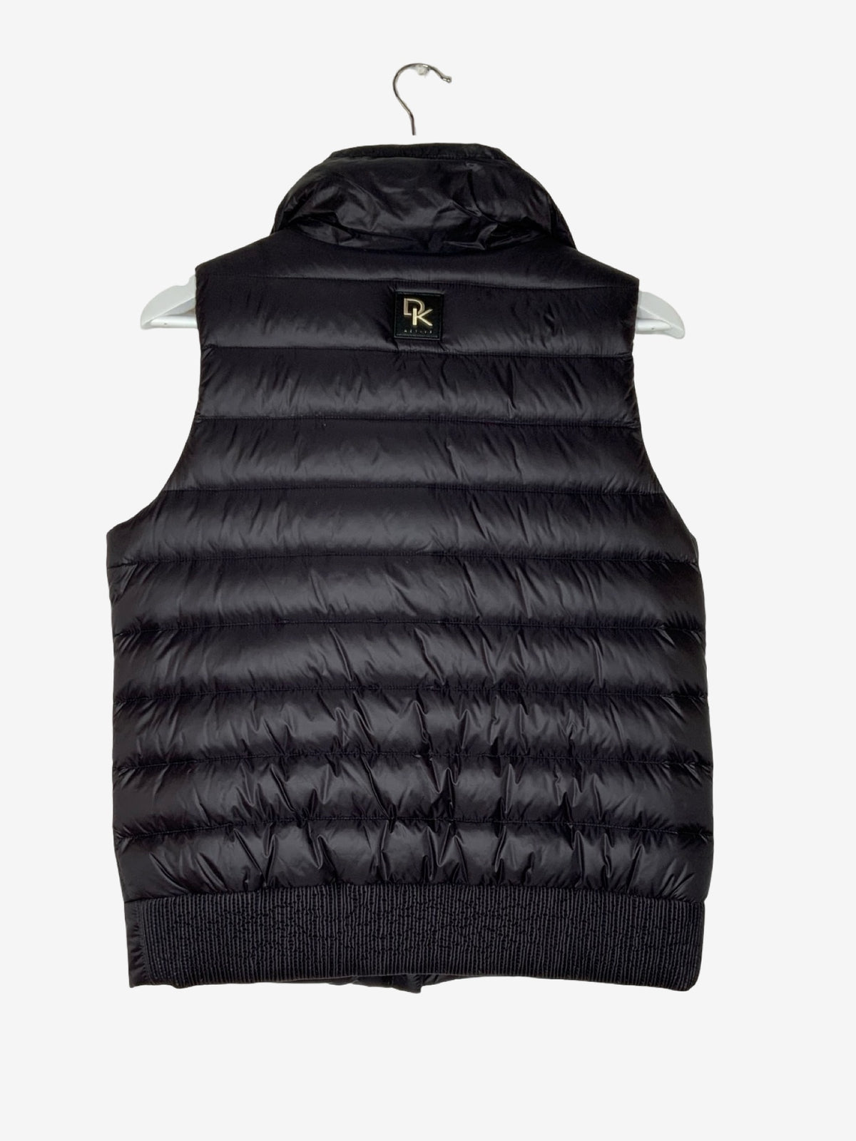 Black down gilet with DK logo on a light gray background