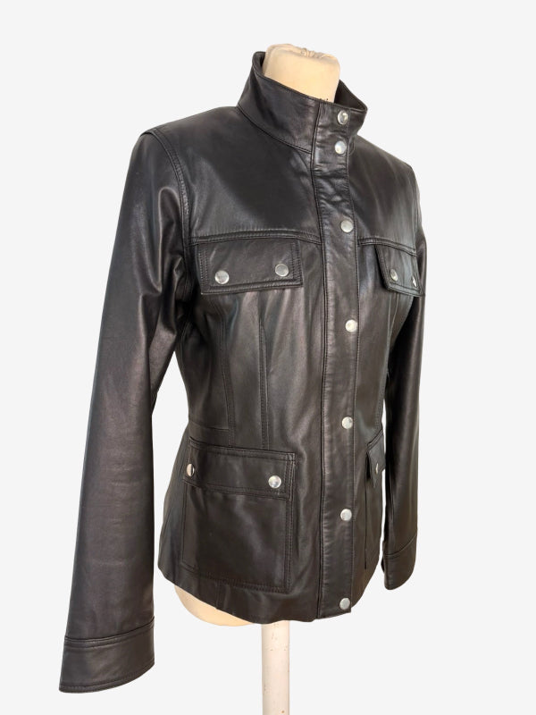 A black leather jacket with a stand collar and silver snap buttons, displayed on a beige mannequin torso against a light gray background.
