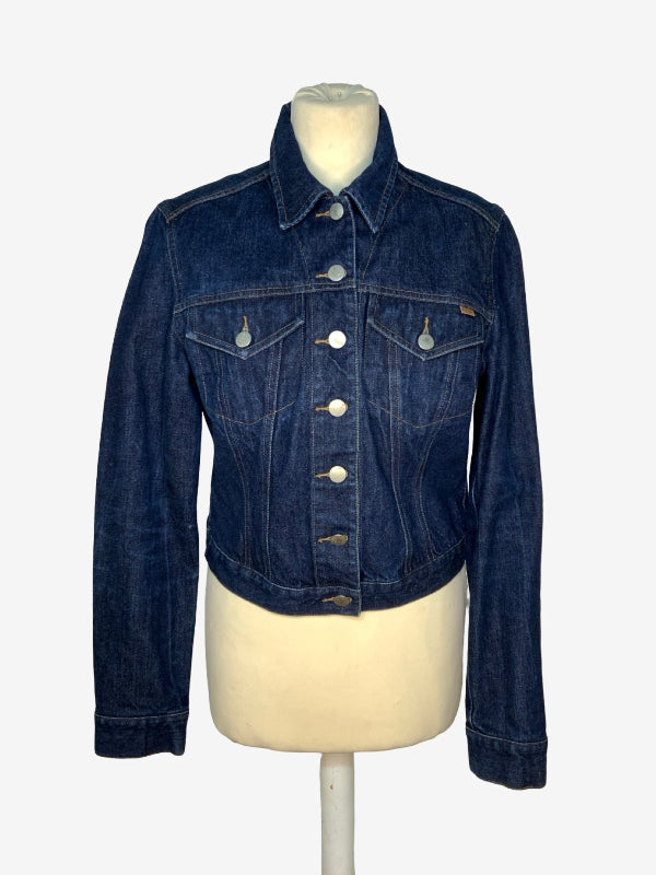 A dark blue denim jacket displayed on a cream-colored mannequin torso against a light gray background.
