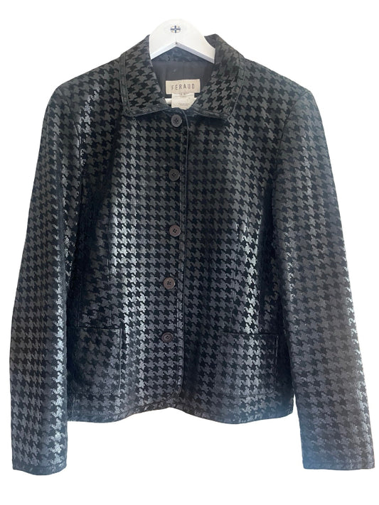 A black and gray houndstooth patterned jacket with a pointed collar and front buttons, hanging on a white hanger against a white background. The brand label reads 'SERANI'.