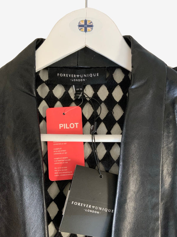 A black faux leather jacket by Forever Unique London hanging on a white hanger with a Pilot logo. The cape  is shown with its black and white harlequin patterned lining and attached red and black hang tags.