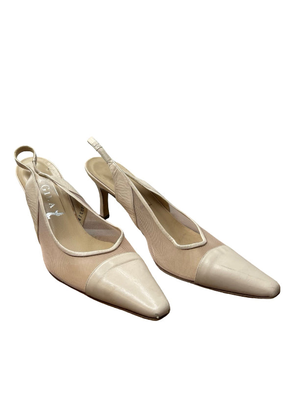 A pair of beige pointed-toe slingback pumps with a glossy finish, displayed on a clean white background.