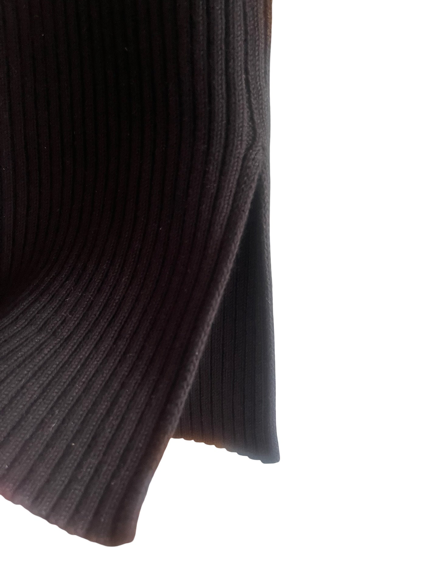 Close-up of a black ribbed knit fabric, showing the texture and fold against a plain white background.