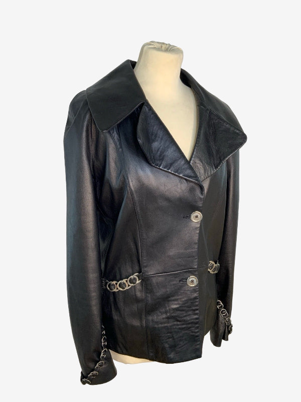 A black leather jacket with silver chain accents and silver buttons, displayed on a cream-colored mannequin torso against a light gray background.