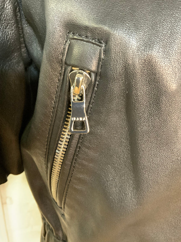 Close-up of a black leather jacket featuring a vertical zippered pocket with a silver-toned metal zipper and pull tab engraved with the brand name 'ISARA'.