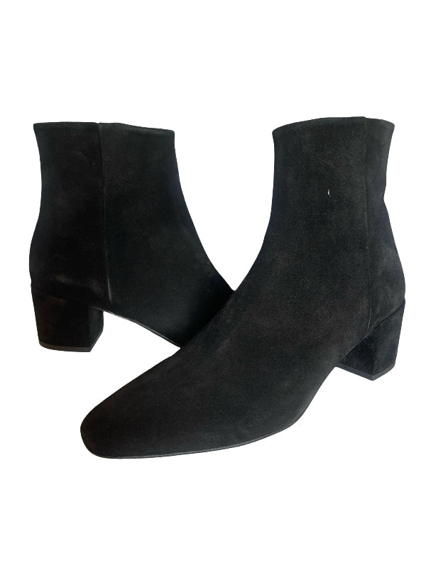 A pair of black suede ankle boots with low block heels, displayed against a solid white background.