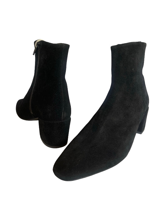A pair of black suede ankle boots with low block heels, shown from the side and front angles against a plain white background.