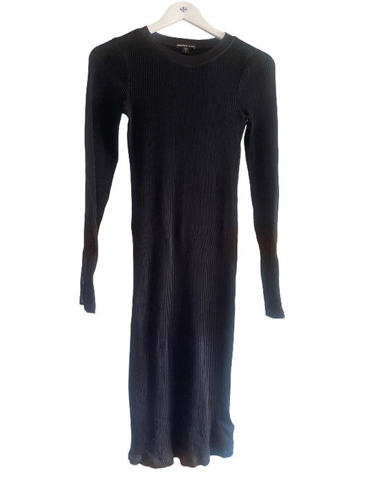 A long-sleeve ribbed knit midi dress in black, hanging on a white hanger against a plain white background.